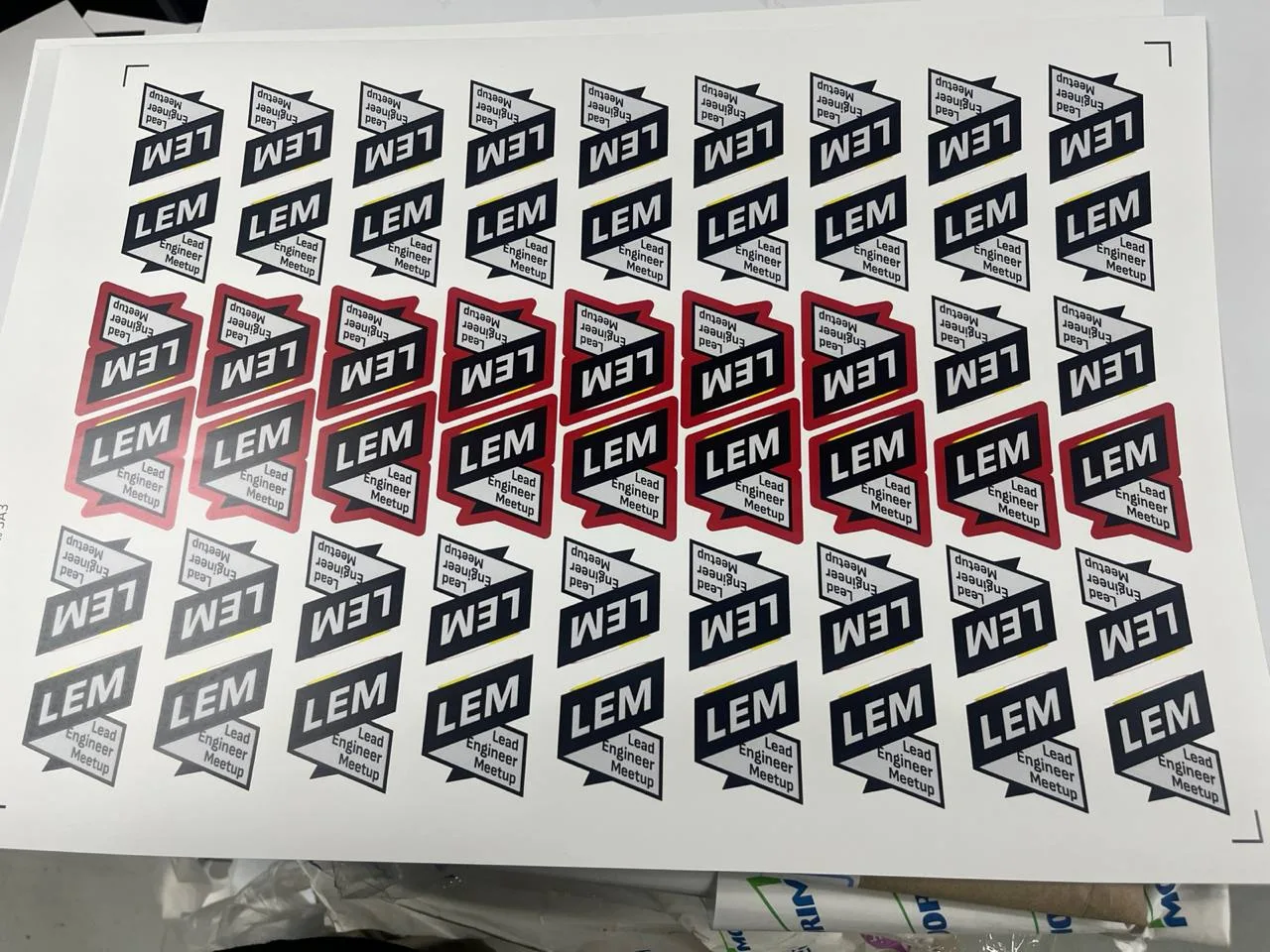 Sheets of LEM ribbon stickers fresh off the press, including a red-outlined variant